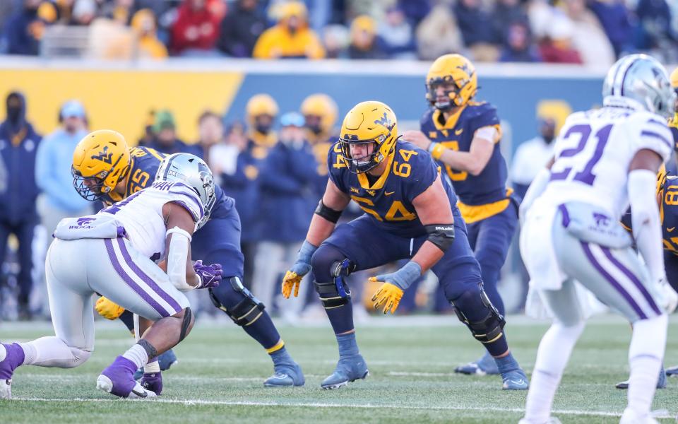 Nov 19, 2022; Morgantown, West Virginia, USA; West Virginia Mountaineers offensive lineman Wyatt Milum (64) during a play during the third quarter against the Kansas State Wildcats at Mountaineer Field at Milan Puskar Stadium. Mandatory Credit: Ben Queen-USA TODAY Sports