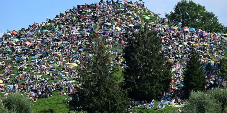 Fans sat on the Olympiaberg in the Olympiapark in the sunshine waiting for the Taylor Swift concert to begin.