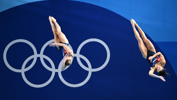 Kassidy Cook and Sarah Bacon of the U.S. compete in the women's synchronized 3-meter springboard diving final at the Paris 2024 Olympic Games at the Aquatics Centre in Saint-Denis, north of Paris, on Saturday. They won silver, the first U.S. medal in the event since 2012.