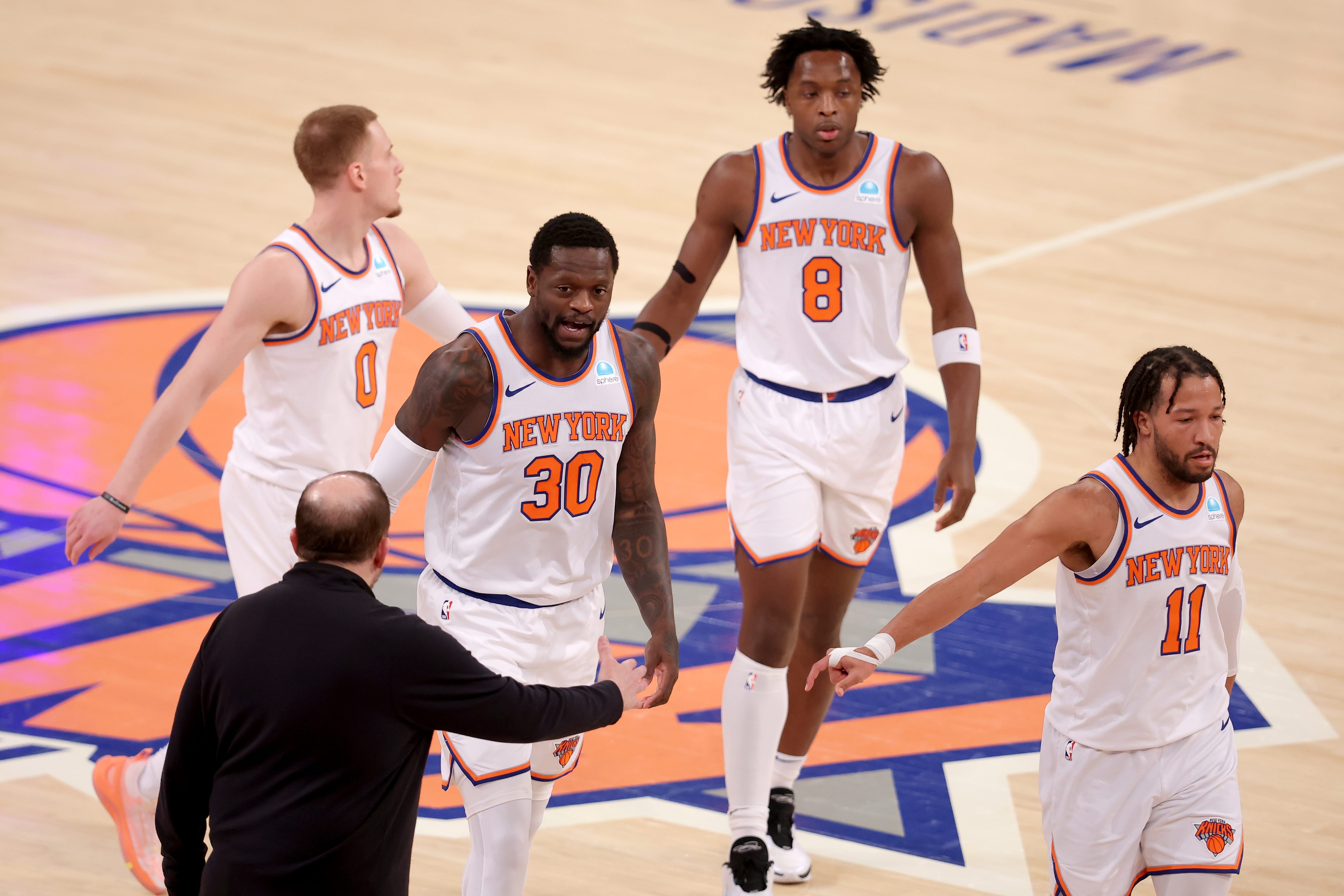 New York Knicks head coach Tom Thibodeau high fives New York Knicks forward Julius Randle (30) with guard Donte DiVincenzo (0) and forward OG Anunoby (8) and guard Jalen Brunson (11) during the first quarter against the Washington Wizards at Madison Square Garden