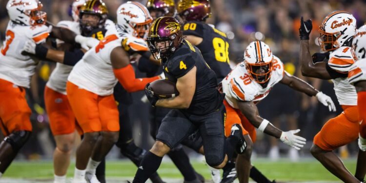 Sep 9, 2023; Tempe, Arizona, USA; Arizona State Sun Devils running back Cam Skattebo (4) against the Oklahoma State Cowboys at Mountain America Stadium. Mandatory Credit: Mark J. Rebilas-USA TODAY Sports