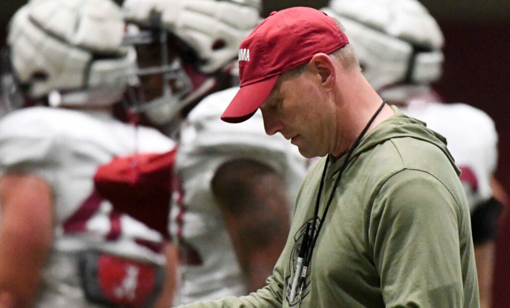 April 9, 2024; Tuscaloosa, Alabama, USA; Alabama head coach Kalen DeBoer checks his play sheet during practice in the Hank Crisp Indoor Practice Facility at the University of Alabama.