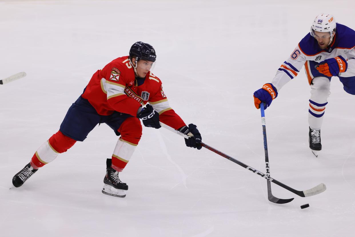 Jun 24, 2024; Sunrise, Florida, USA; Florida Panthers forward Anton Lundell (15) and Edmonton Oilers defenseman Philip Broberg (86) reach for the puck during the second period in game seven of the 2024 Stanley Cup Final at Amerant Bank Arena. Mandatory Credit: Sam Navarro-USA TODAY Sports