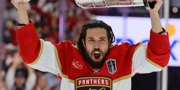 Jun 24, 2024; Sunrise, Florida, USA; Florida Panthers forward Ryan Lomberg (94) hoists the Stanley Cup after defeating the Edmonton Oilers in game seven of the 2024 Stanley Cup Final at Amerant Bank Arena. Mandatory Credit: Sam Navarro-USA TODAY Sports