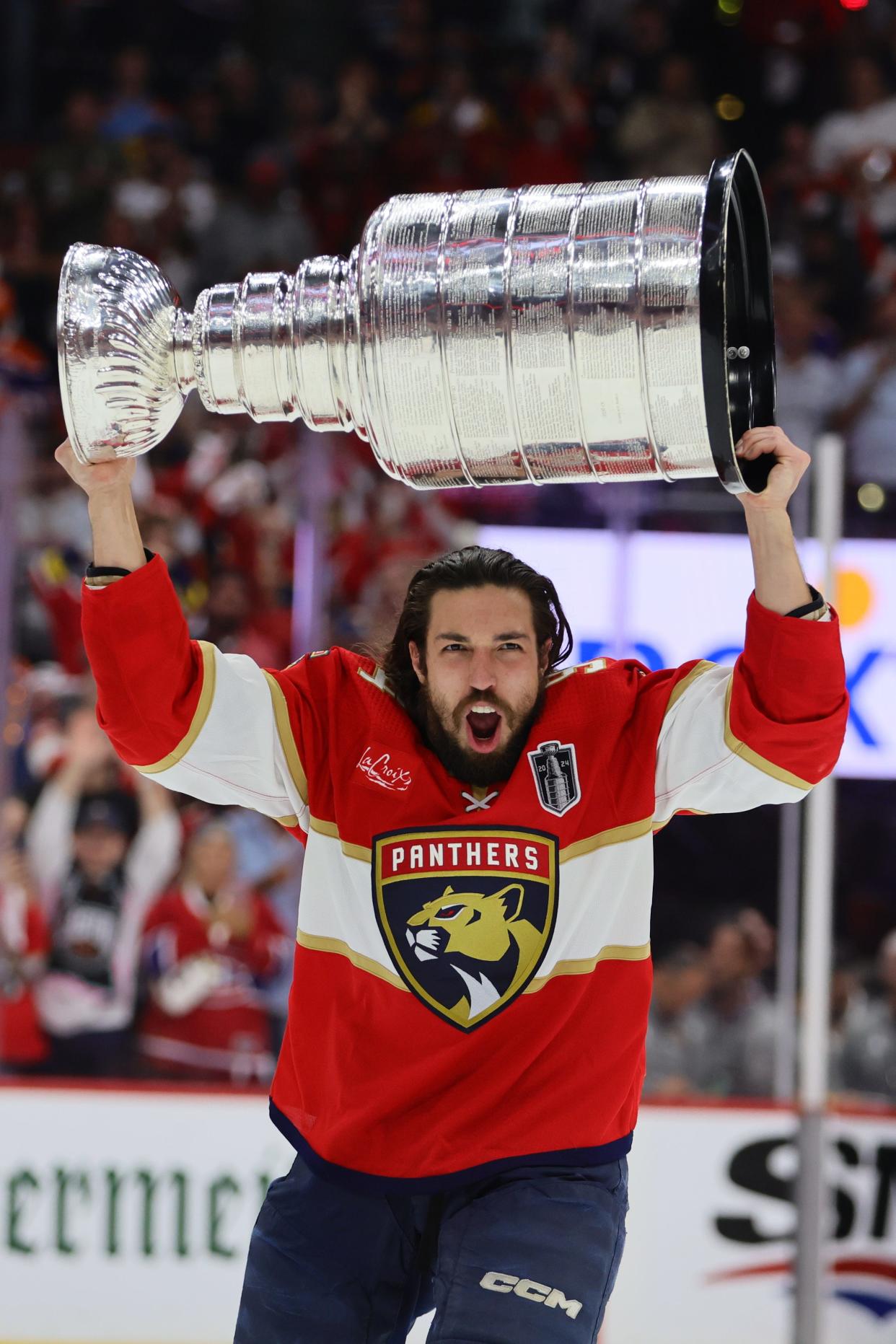 Jun 24, 2024; Sunrise, Florida, USA; Florida Panthers forward Ryan Lomberg (94) hoists the Stanley Cup after defeating the Edmonton Oilers in game seven of the 2024 Stanley Cup Final at Amerant Bank Arena. Mandatory Credit: Sam Navarro-USA TODAY Sports