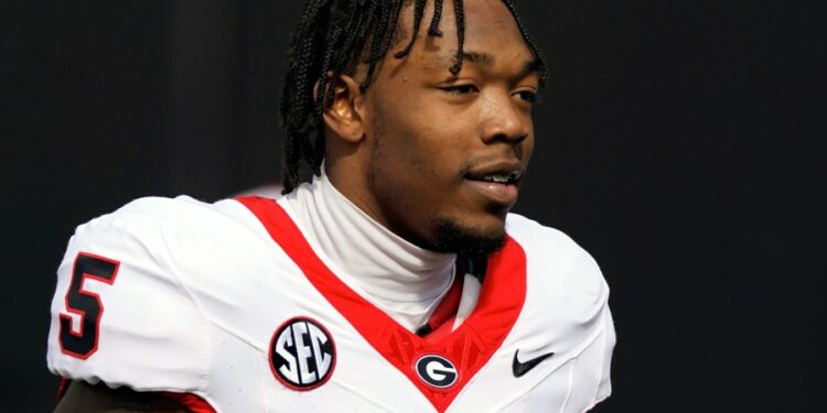 FILE - Georgia wide receiver Rara Thomas (5) warms up before an NCAA college football game against Vanderbilt, Saturday, Oct. 14, 2023, in Nashville, Tenn. Thomas was arrested on charges of cruelty to children and battery early Friday, July 26, 2024, in Athens, Ga., adding to the team's recent legal woes. (AP Photo/George Walker IV, File)