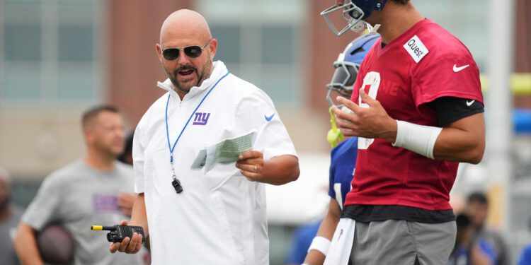 Jul 25, 2024; East Rutherford, NY, USA; New York Giants head coach Brian Daboll speaks with quarterback Daniel Jones (8) during training camp at Quest Diagnostics Training Center. Mandatory Credit: Lucas Boland-USA TODAY Sports