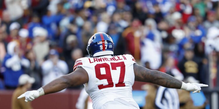 Nov 19, 2023; Landover, Maryland, USA; New York Giants defensive tackle Dexter Lawrence II (97) celebrates after an interception against the Washington Commanders during the fourth quarter at FedExField. Mandatory Credit: Geoff Burke-USA TODAY Sports