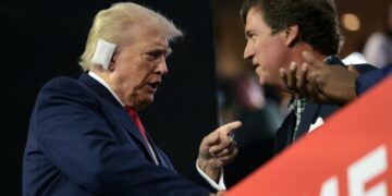 Donald Trump speaks with Tucker Carlson at the convention