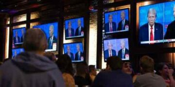 Guests watch a debate between President Joe Biden and presumptive Republican nominee former President Donald Trump