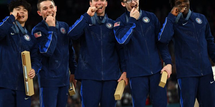 Team USA poses with their bronze medal during the podium ceremony for the artistic gymnastics men's team final