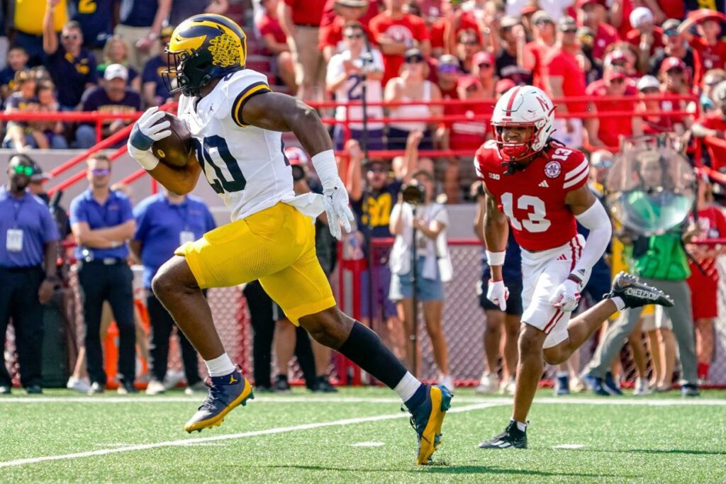 Sep 30, 2023; Lincoln, Nebraska, USA; Michigan Wolverines running back Kalel Mullings (20) runs for a touchdown against Nebraska Cornhuskers defensive back Malcolm Hartzog (13) during the first quarter at Memorial Stadium. Mandatory Credit: Dylan Widger-USA TODAY Sports