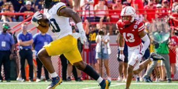 Sep 30, 2023; Lincoln, Nebraska, USA; Michigan Wolverines running back Kalel Mullings (20) runs for a touchdown against Nebraska Cornhuskers defensive back Malcolm Hartzog (13) during the first quarter at Memorial Stadium. Mandatory Credit: Dylan Widger-USA TODAY Sports