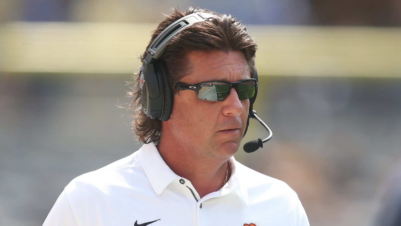 Mike Gundy wearing a headset