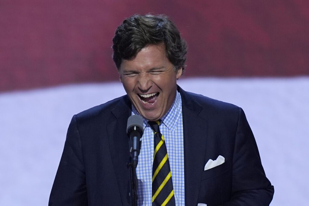 Tucker Carlson walks up to the podium to speak on the final day of the Republican National Convention on Thursday, July 18, 2024, in Milwaukee.