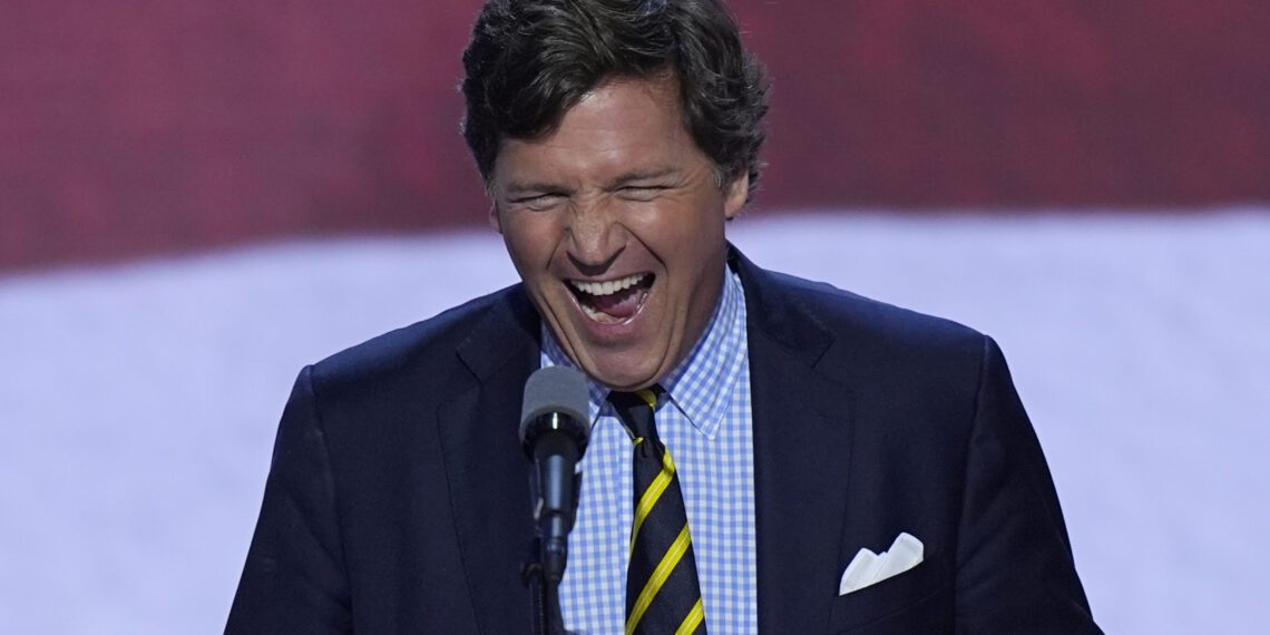 Tucker Carlson walks up to the podium to speak on the final day of the Republican National Convention on Thursday, July 18, 2024, in Milwaukee.