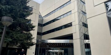 People walk toward the James M. Fitzgerald U.S. Courthouse and Federal Building in downtown Anchorage, Alaska, Wednesday, July 10, 2024. U.S. District Court Judge Joshua Kindred of Alaska has resigned and could face impeachment after having an inappropriate sexual relationship with a clerk who later became an assistant U.S. Attorney and then repeatedly lying about it to investigators, a judicial investigation found. (AP Photo/Mark Thiessen)