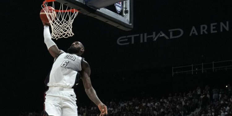 United States' LeBron James scores during an exhibition basketball match between Serbia and the United States at the USA Basketball Showcase, ahead of the 2024 Paris Olympic basketball tournament, in Abu Dhabi, United Arab Emirates, Wednesday, July 17, 2024. (AP Photo/Altaf Qadri)