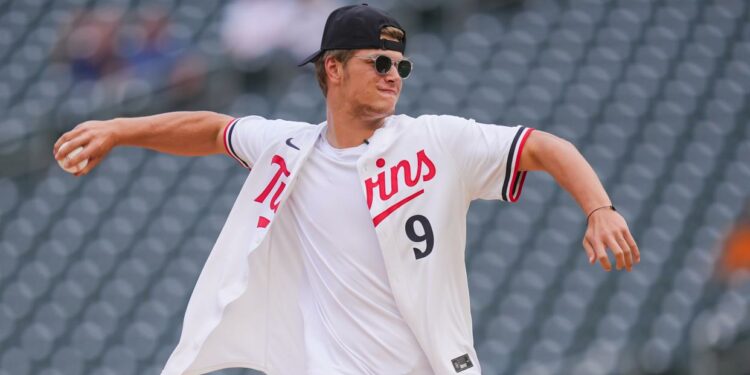 Jun 18, 2024; Minneapolis, Minnesota, USA; Minnesota Vikings first round draft pick JJ McCarthy throws out the ceremonial first pitch in a game between the Minnesota Twins and Tampa Bay Rays at Target Field. Mandatory Credit: Brad Rempel-USA TODAY Sports ORG XMIT: IMAGN-738378 ORIG FILE ID: 20240618_szo_ai9_0073.JPG