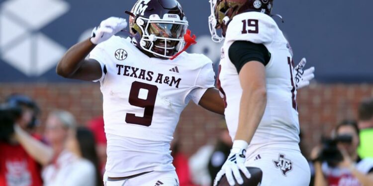 Nov 4, 2023; Oxford, Mississippi, USA; Texas A&M Aggies wide receiver Jahdae Walker (9) races with tight end Jake Johnson (19) after a touchdown during the second half against the Mississippi Rebels at Vaught-Hemingway Stadium. Mandatory Credit: Petre Thomas-USA TODAY Sports