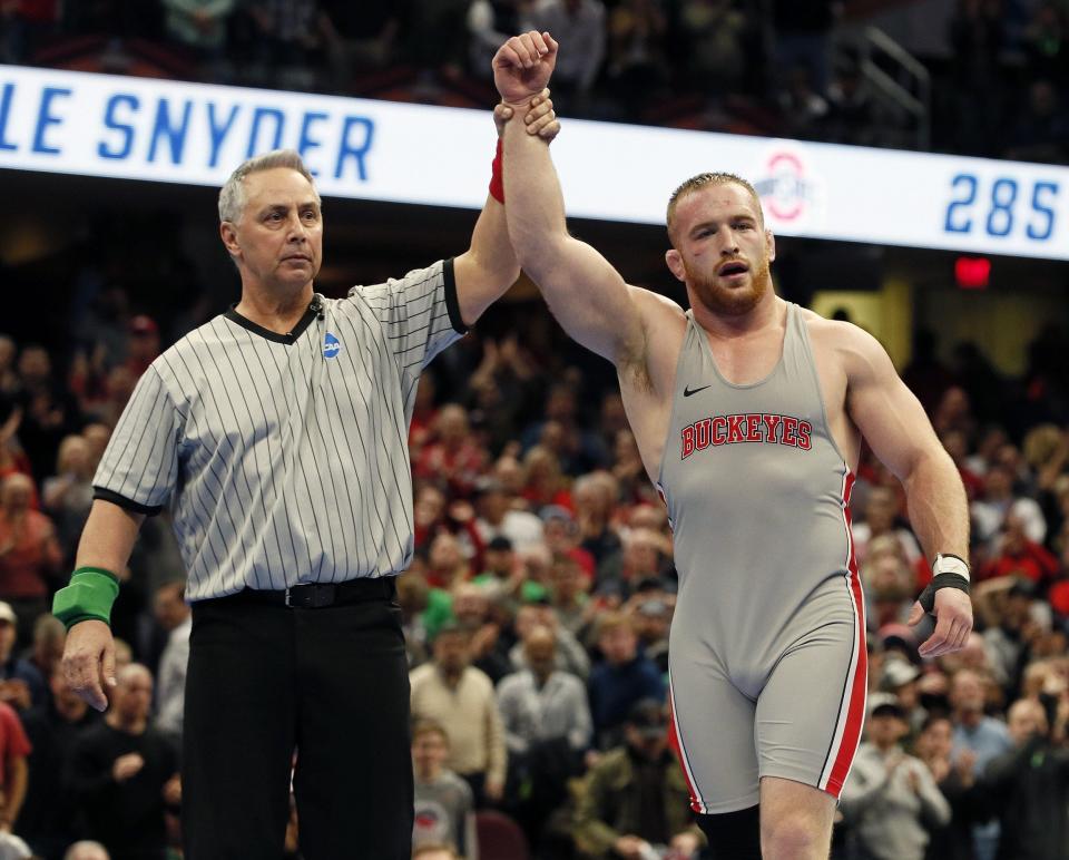 Ohio State's Kyle Snyder celebrates after winning his third national title, this time by beating Michigan's Adam Conn 3-2 Saturday night in the finals of the 285-pound weight class at Quicken Loans Arena in Cleveland. [Kyle Robertson]