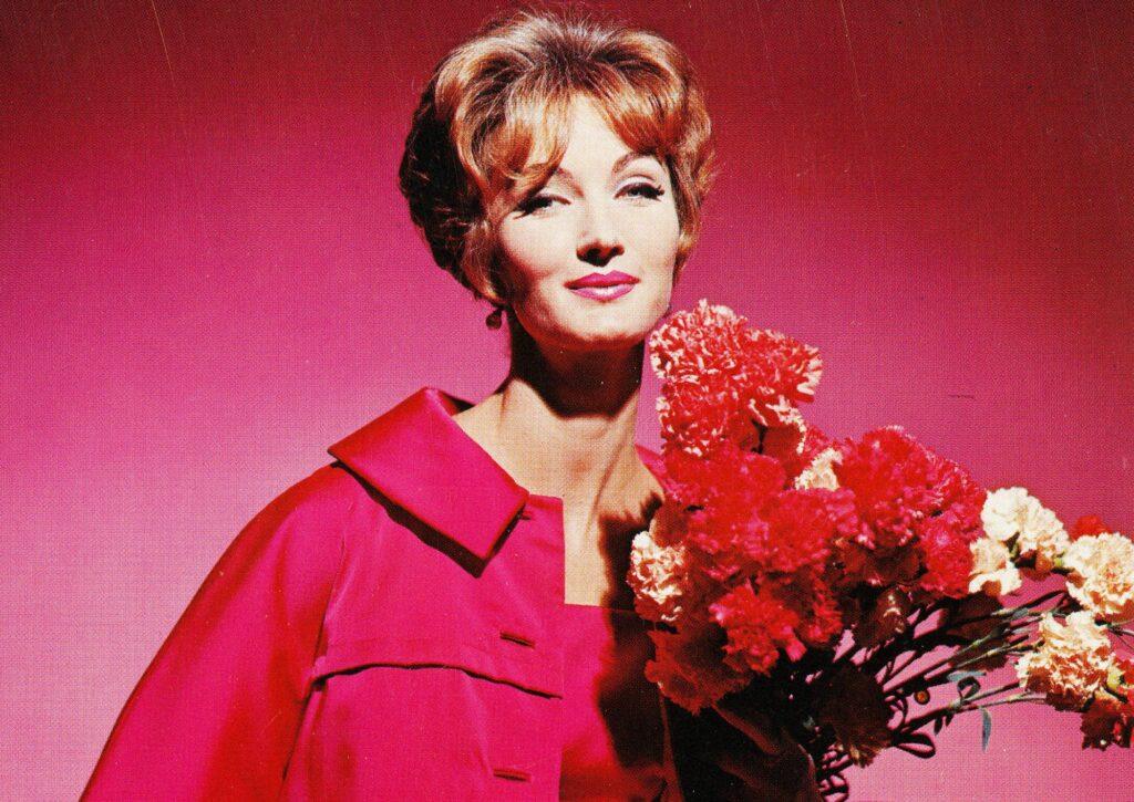 A model holds Colorado carnations in a Vogue ad.