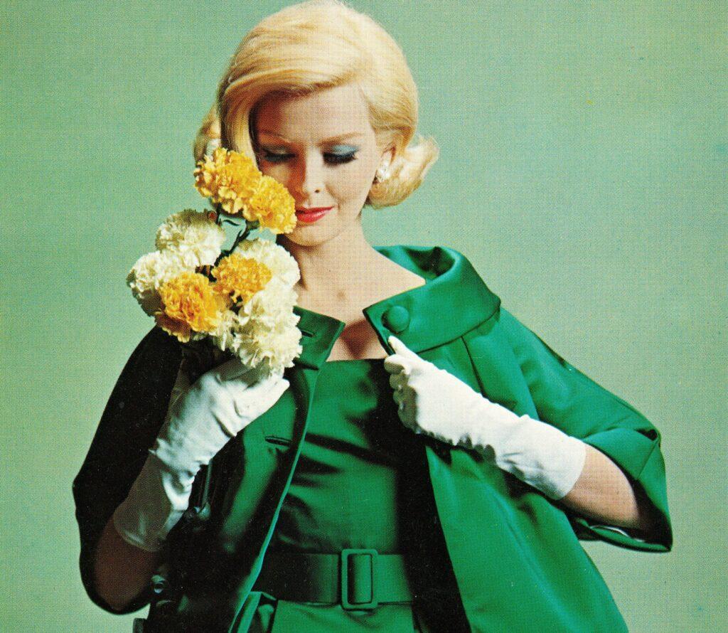 A model holds Colorado carnations in a Vogue ad.