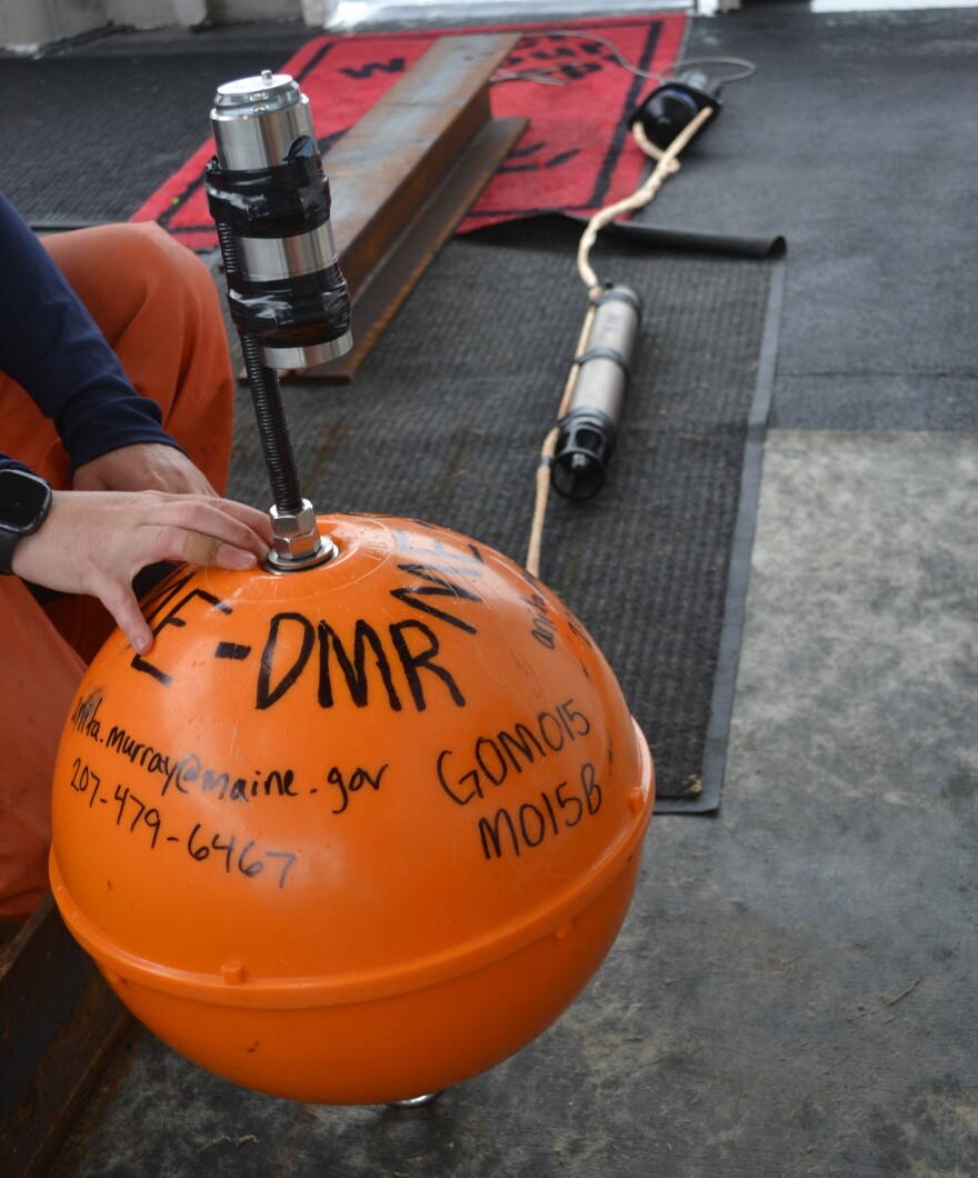 A team from the Department of Marine Resources prepares to deploy this passive acoustic monitor to a predetermined point in the Gulf of Maine. The receiver continuously records vocalizations from right whales and other marine life when placed under water.