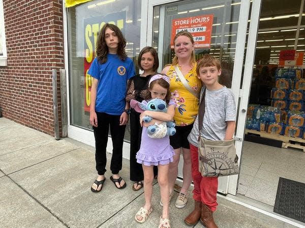 Voluntown resident Erica Tefft, in front of the store hours sign, shopped at the Norwich Big Lots store Tuesday along with her four kids; Alexander Conti, 14, Annabella Conti, 11, Antoinette Conti, 8, and Ace Conti, 10. Tefft didn't know the Norwich location was closing until she arrived.