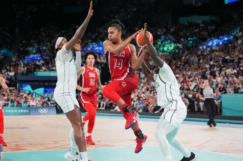 Team USA's Alyssa Thomas (C) jumps while being defended by Nigeria's Elizabeth Balogun (L) and Murjanatu Musa during a Summer Olympics women's basketball quarterfinal Wednesday in Paris. Photo by Richard Ellis/UPI