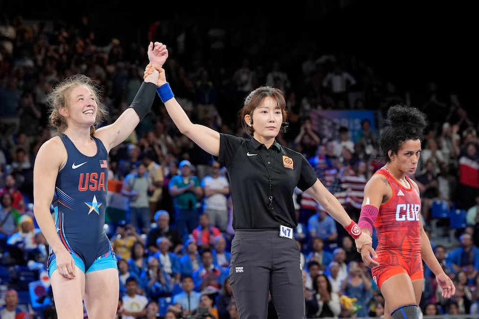 United State's Sarah Hildebrandt celebrates after defeating Cuba's Yusneylis Guzman, right, in...