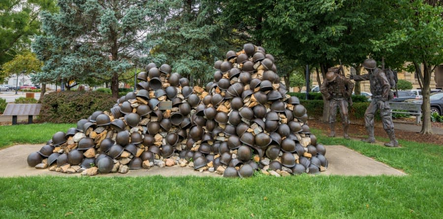 Zanesville, OH – Sept. 8, 2021: This pile of helmets and bronze figures are part of the WWII Korean War Memorial honoring the fallen men from Muskingum County by sculptor Alan Cottrill.