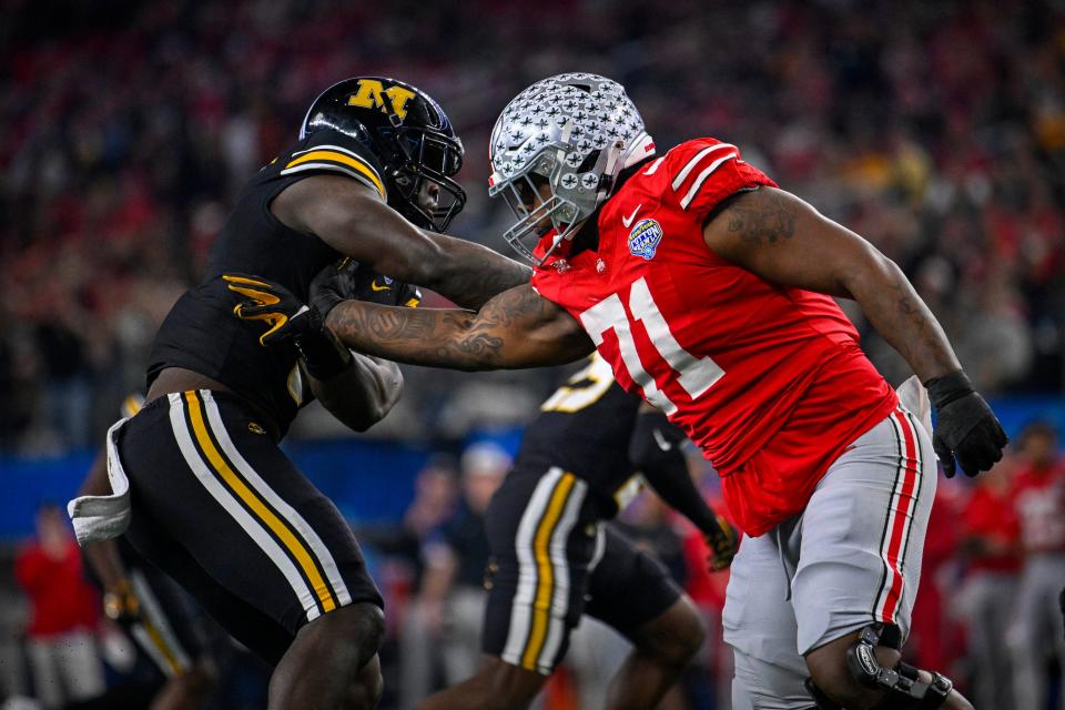 Dec 29, 2023; Arlington, TX, USA; Ohio State Buckeyes offensive lineman Josh Simmons (71) blocks Missouri Tigers defensive lineman Darius Robinson (6) during the second quarter at AT&T Stadium. Mandatory Credit: Jerome Miron-USA TODAY Sports