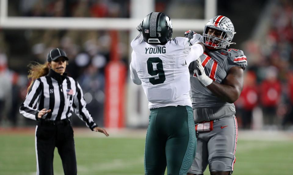 Nov 11, 2023; Columbus, Ohio, USA; Ohio State Buckeyes offensive lineman Josh Simmons (71) and Michigan State Spartans defensive lineman Zion Young (9) have an altercation during the fourth quarter at Ohio Stadium. Mandatory Credit: Joseph Maiorana-USA TODAY Sports