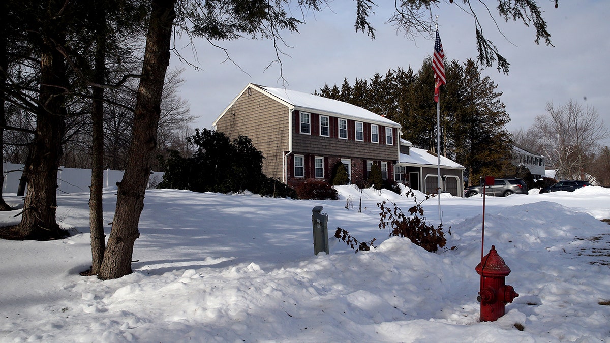 Two story colonial house in the snow