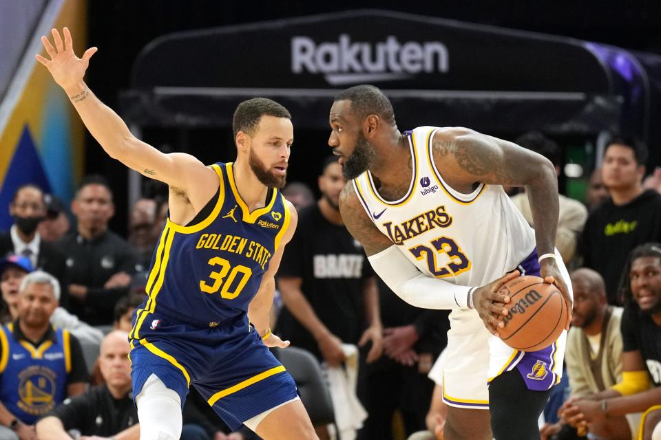 Jan 27, 2024; San Francisco, California, USA; Los Angeles Lakers forward LeBron James (23) handles the ball against Golden State Warriors guard Stephen Curry (30) during overtime at Chase Center. Mandatory Credit: Darren Yamashita-USA TODAY Sports