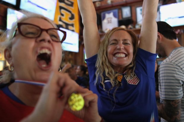 Fans celebrate at an Olympics viewing party at Legends Sports...