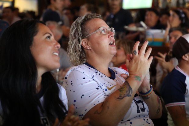 Fans react during an Olympics viewing party at Legends Sports...