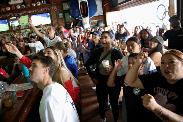 Fans react during an Olympics viewing party at Legends Sports...