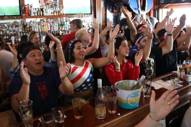 Fans react during an Olympics viewing party at Legends Sports...