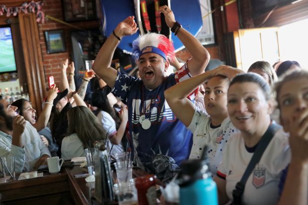 Fans react during an Olympics viewing party at Legends Sports...