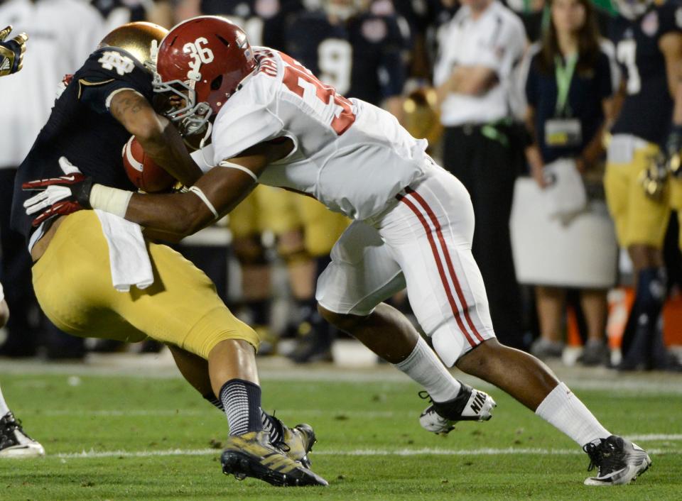 Jan 7, 2013; Miami, FL, USA; Alabama Crimson Tide linebacker Tyler Hayes (36) hits Notre Dame Fighting Irish running back George Atkinson III (4) during the first half of the 2013 BCS Championship game at Sun Life Stadium. Mandatory Credit: Eileen Blass-USA TODAY Sports