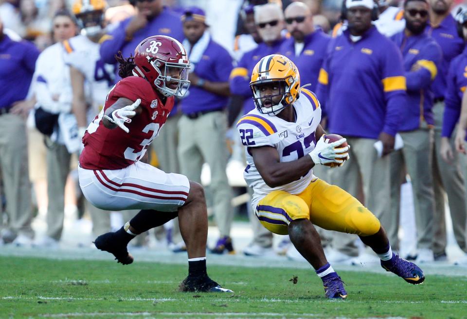 Nov 9, 2019; Tuscaloosa, AL, USA; LSU Tigers running back Clyde Edwards-Helaire (22) runs the ball against Alabama Crimson Tide linebacker Markail Benton (36) during the first half at Bryant-Denny Stadium. Mandatory Credit: Butch Dill-USA TODAY Sports