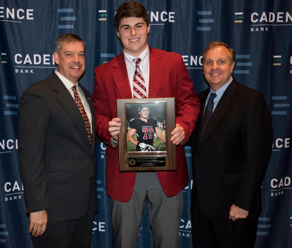 Hewitt-Trussville's Pierce Quick is awarded the Class 7A lineman of the year by President of Mr. Football Jamie Lee, left, and Cadence Bank Senior Vice President Bill Bennett, right, during the Mr. Football awards banquet in Montgomery, Ala., on Tuesday, Jan. 15, 2019. 

Jc Mrfootball 28