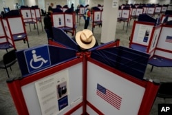 FILE - Rod Sommer fills out his ballot during early voting in Cincinnati on Oct. 11, 2023. Voters approved on Nov. 7, 2023, an amendment to the Ohio Constitution to protect access to abortion.