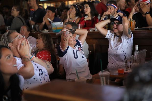 Fans react during an Olympics viewing party at Legends Sports...