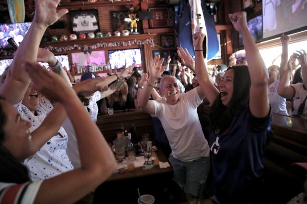 Fans react at an Olympics viewing party at Legends Sports...