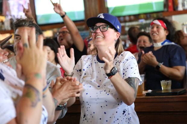 Fans react at an Olympics viewing party at Legends Sports...