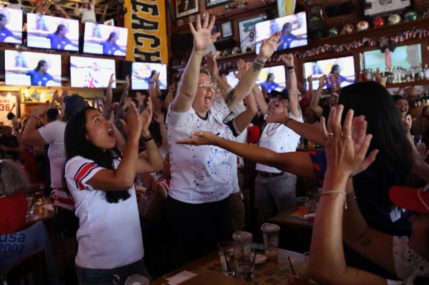 Fans react at an Olympics viewing party at Legends Sports...