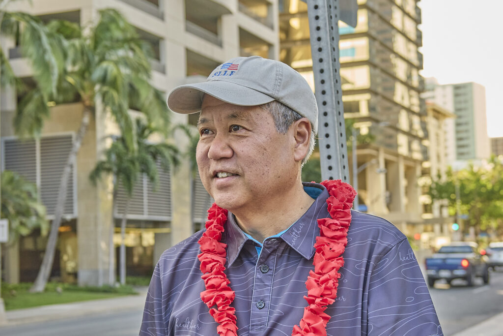 Hawaii Speaker of the House Scott Saiki was joined on Friday afternoon by Hawaii Gov. Josh Green at the corner of South Beretania and Alakea streets to sign wave during afternoon drive time. July 5th, 2024 (David Croxford/Civil Beat/2024)